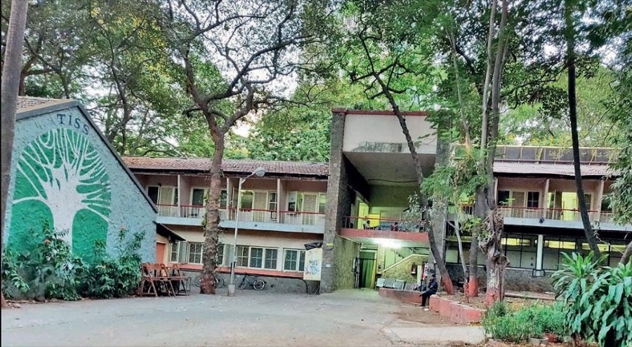 The Tata Institute of Social Sciences campus at Deonar, Mumbai β low buildings among mature trees, with the TISS tree mural on an end wall